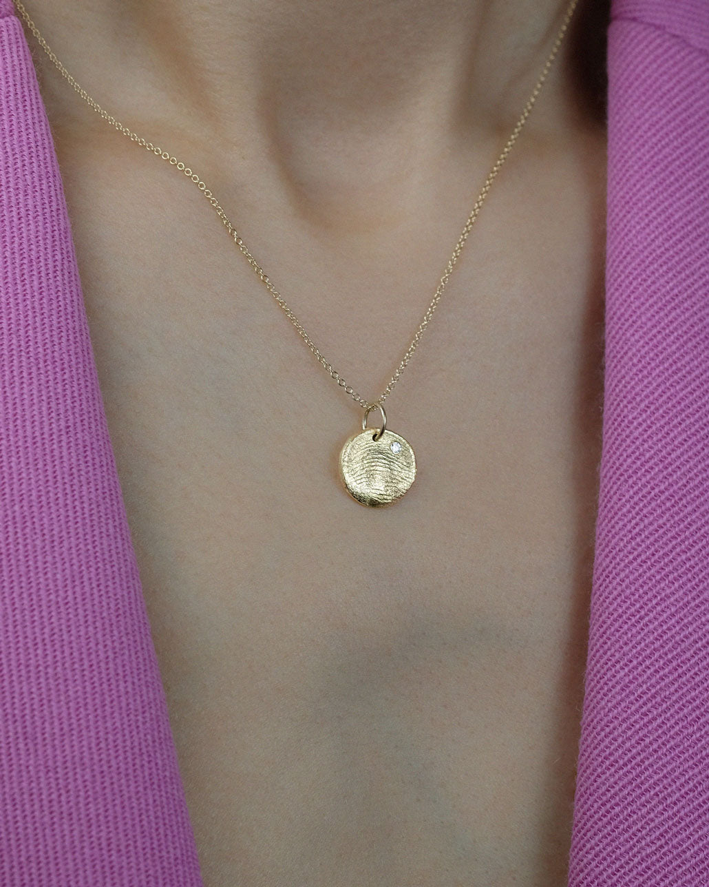 Mini Fingerprint Charm in solid gold with a diamond